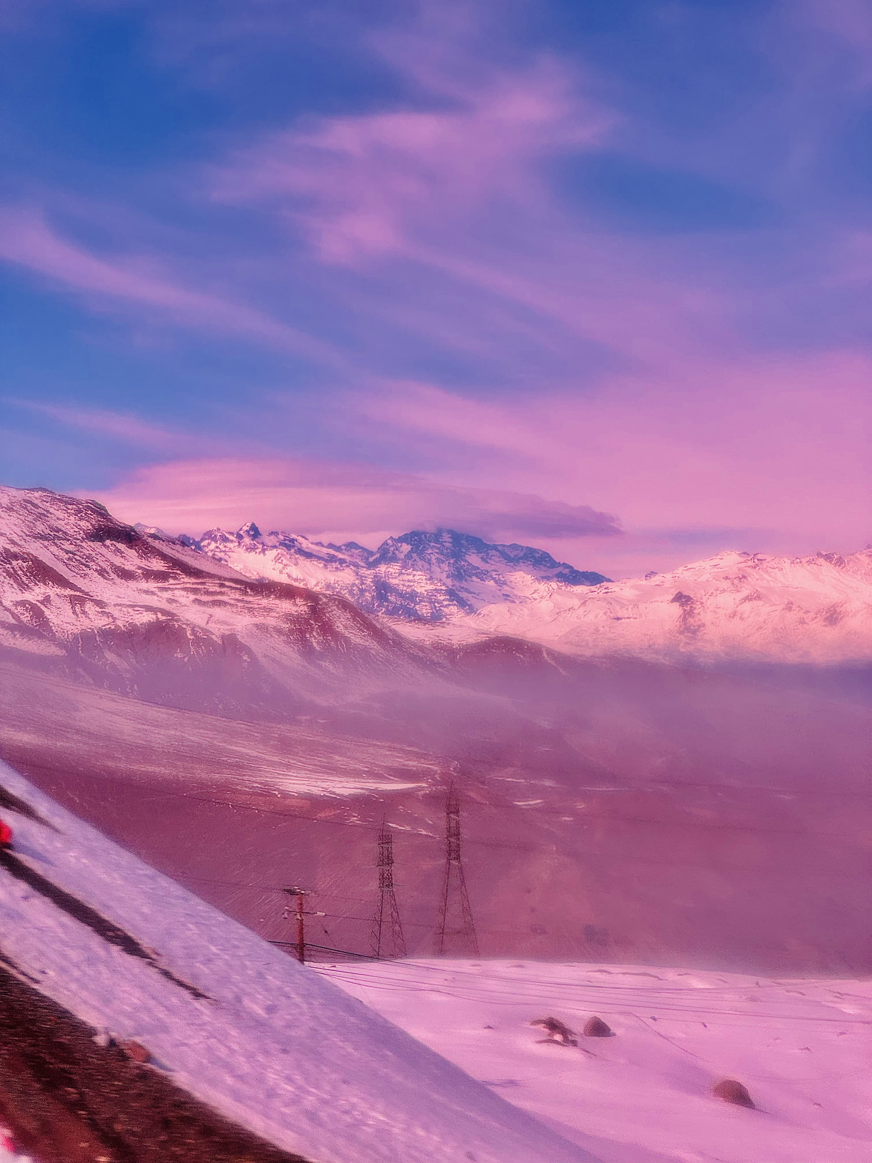 Pink-toned, dreamy-looking picture of the Andes mountains in Chile.