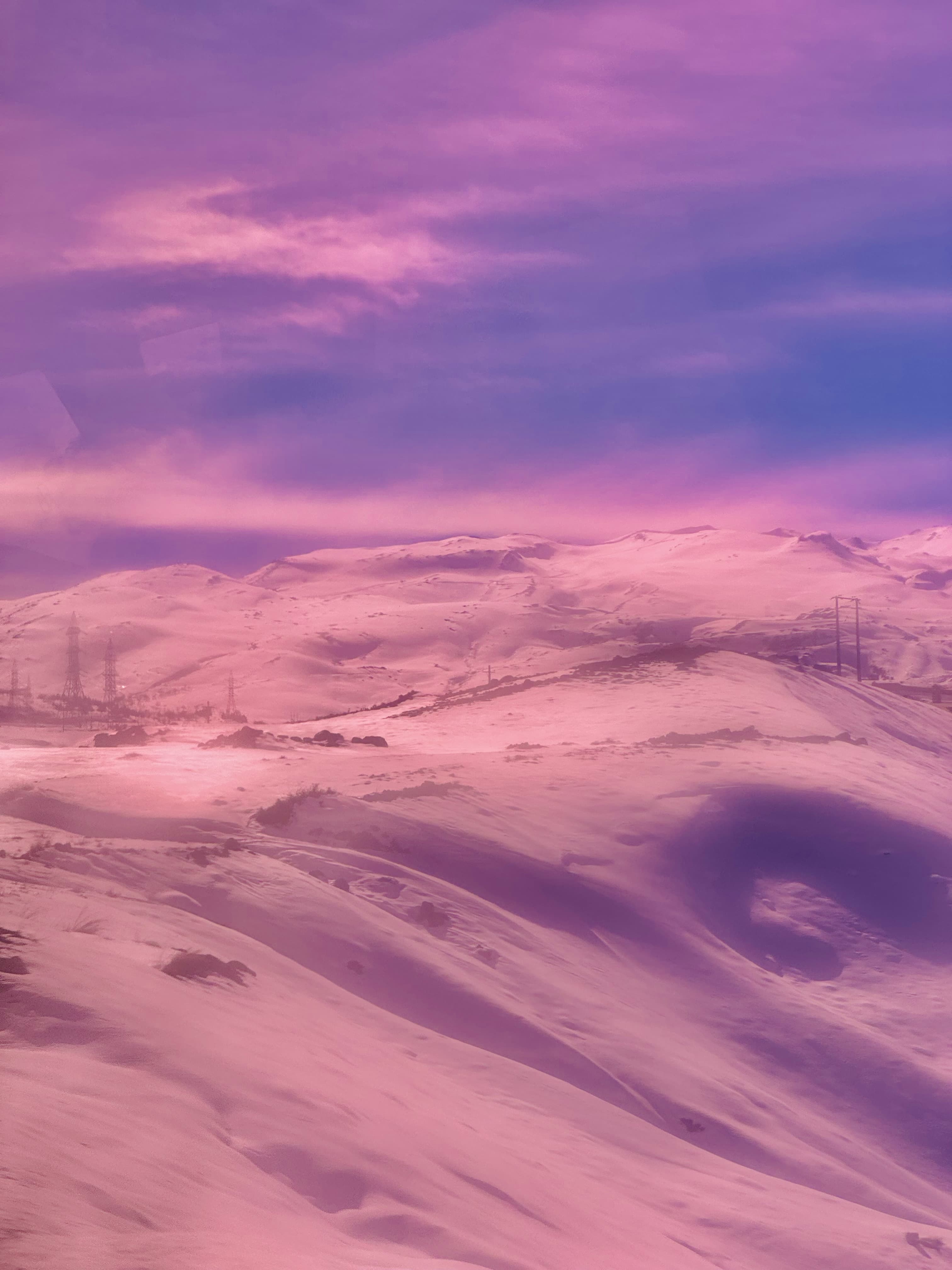 Pink-toned, dreamy-looking picture of the Andes mountains in Chile.