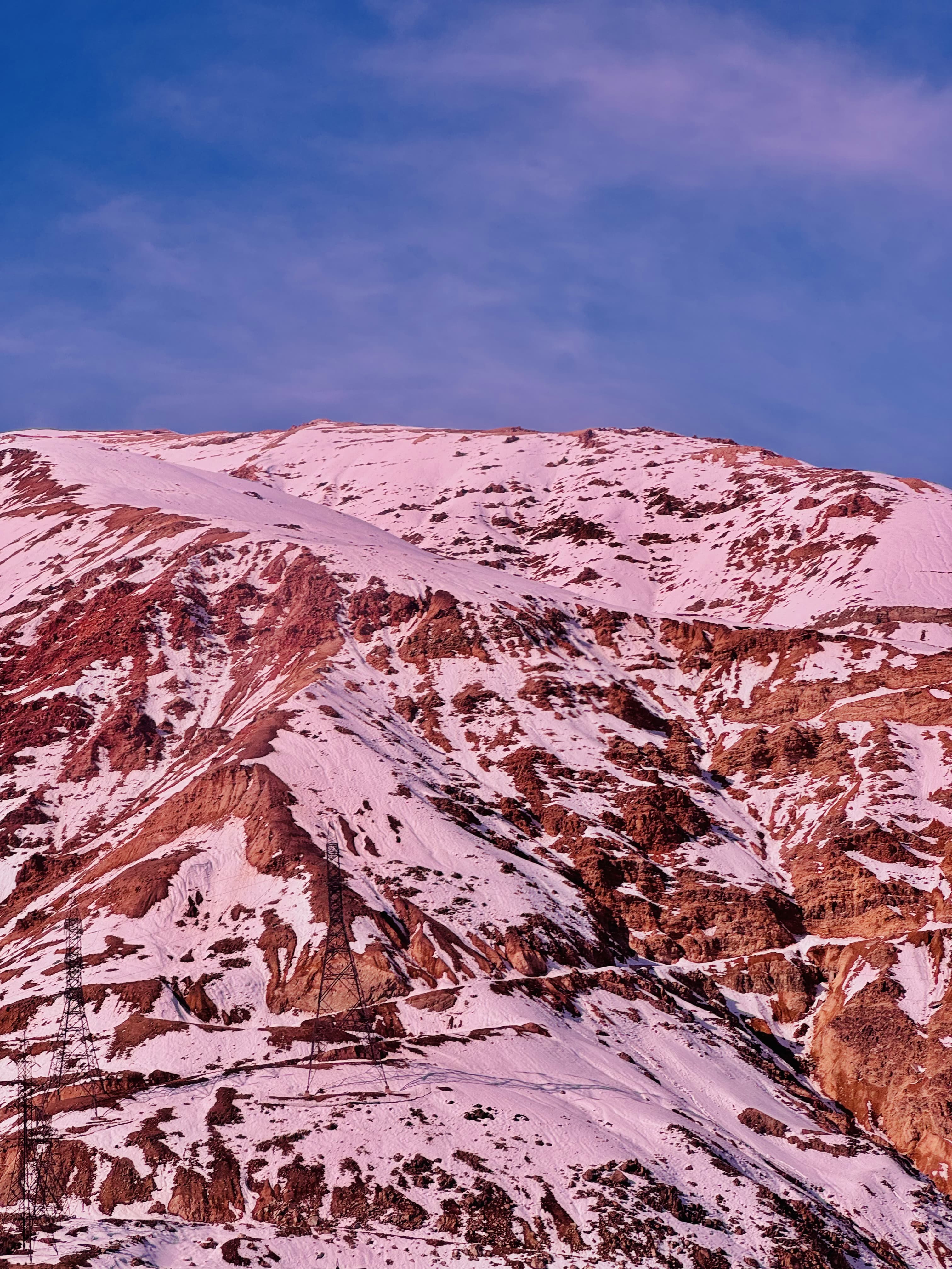 Pink-toned, dreamy-looking picture of the Andes mountains in Chile.